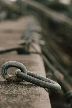 A strong metal ring embedded in stone stands ready to secure boats, embodyi.. Fotos de archivo