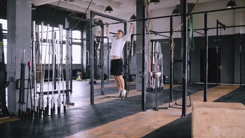 Strong middle-aged man pulls up on bar in gym Stock Footage 116651946