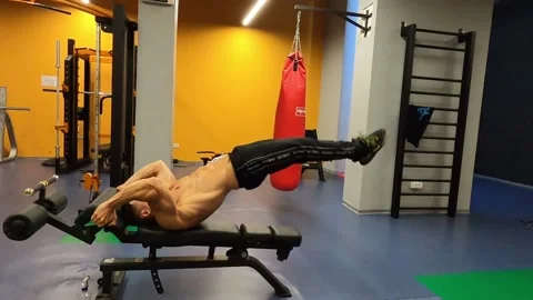 Strong muscular guy doing dragon flag exercise Video stock 138914691
