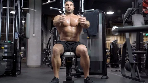 Strong muscular man doing exercise for chest in the gym Stock Footage 108835143
