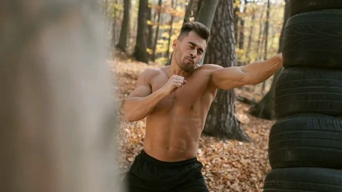 Strong Naked Torso Guy Makes Boxing With His Hands. Autumn Forest. Stock Footage 120652521