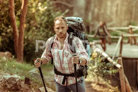 Strong nice young man carrying a backpack Stock Photos