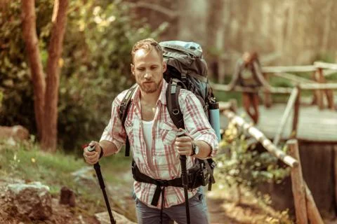 Strong nice young man carrying a backpack Foto stock