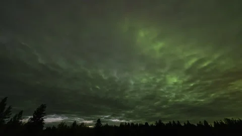 Strong northern lights behind the clouds Stock Footage 250283762