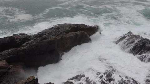Strong ocean wave hitting the shoreline rocks Stock Footage 269443675