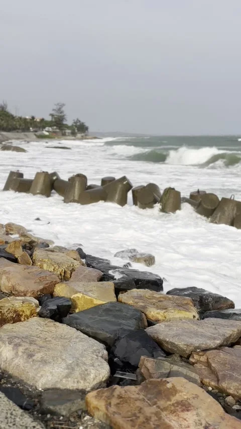 Strong ocean waves crashing against concrete breakwater blocks. Rough sea w.. Stock Footage 340806285