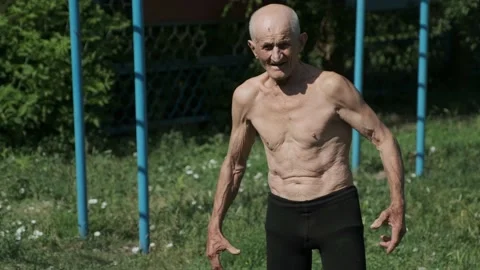 Strong old man demonstrates power straining muscles of bicep Stock Footage 201552065