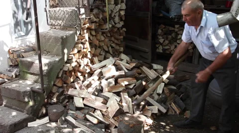 Strong old man splitting wood logs, winter supplies, stack of firewood Stock Footage 41266565