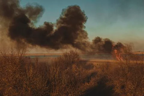 Strong prairie fire with large clouds of choking smoke erupted Stock Photos