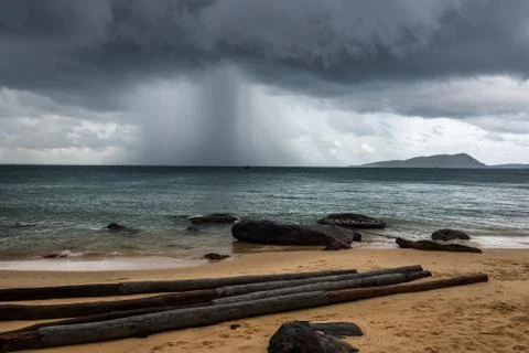 Strong rain cloud beach and trunks on island koh rong Stock Photos