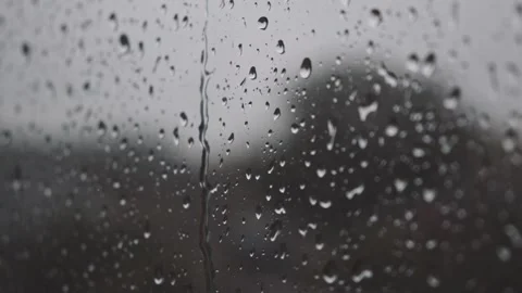 Strong rain creating water drops on window glass in downpour autumn weather Stock Footage 163186233