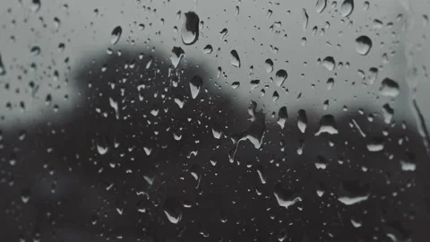 Strong rain water drops stream down on window glass in bad autumn weather Stockbeeldmateriaal 163186243