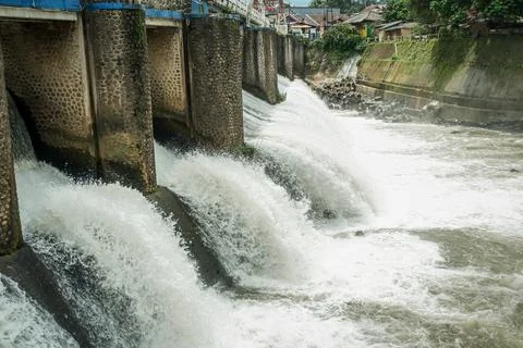 Strong river currents rush over a low katulampa concrete dam Stock Photos
