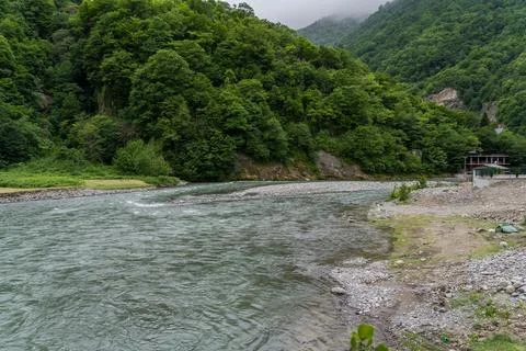 A strong river flows between the mountains of Georgia Stock Photos