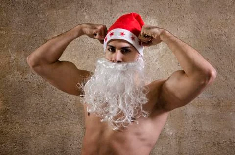 Strong santa posing on wall Stock Photos