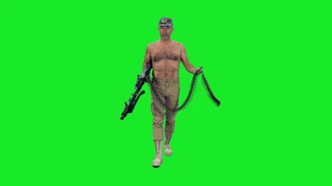 A strong shirtless man walks with machine gun and cartridge belt on green screen Stock Footage 304553000