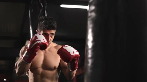 Strong shirtless middle age man training in boxing gym. Extreme combat sports Stock Footage 201404331