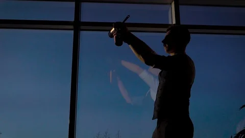 Strong slender man against the background of the pan-arm window. The bartender Stock Footage 124358256