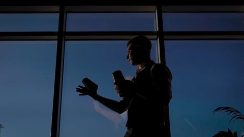 Strong slender man against the background of the pan-arm window. The bartender Stock Footage 128371423