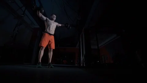 Strong slender man raises dumbbell 库存影片 70967324