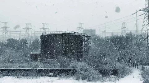 Strong snowfall on the background of factory structures in slow motion Stock Footage 115405406