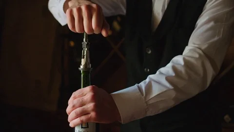 Strong sommelier opens the bottle of wine for visitors in the restoraun. Close Stock Footage