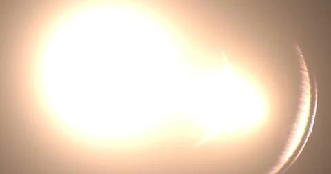 Strong splash of light exploding on the black background like in lens and Stock Photos