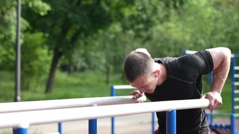 Strong sportsman exercising on pull up bars Stock Footage 244373106