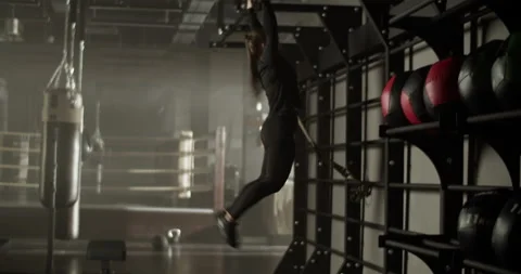 Strong sportswoman doing pull ups exercise in gym Stock Footage 235383210