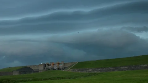 Strong storm front approaching over a dam 2160P Stock Footage 110700071