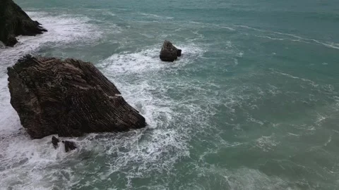 A strong storm sea wave breaks on the rocks standing in the sea, aerial view Stock Footage 268803411