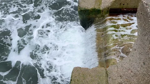 Strong storm waves beating against the stairs going into rough sea, side view Stock Footage 237028068