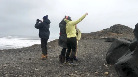 Strong Storm Winds Push Tourists Over While Trying To Take Selfies, Iceland Stock Footage 97390487