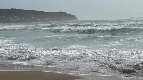 The strong stormy waves crashign on the beach at Sennen Cove, Cornwall. Stock Footage 322073685