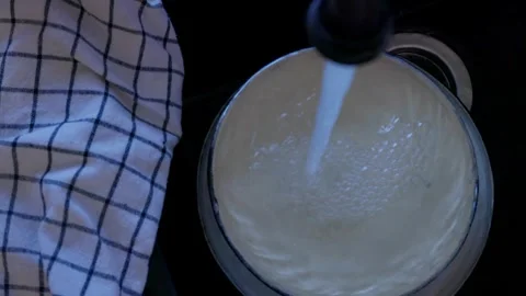 Strong stream of water flowing from kitchen faucet onto dishes in black sink. Cl Stock Footage 329509005