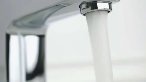 Strong stream of water pouring from chrome tap Stock Footage 72473167