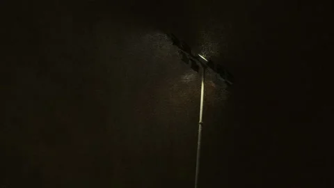 A strong stream of wind and snow passes through the spotlight Stock Footage 147668737