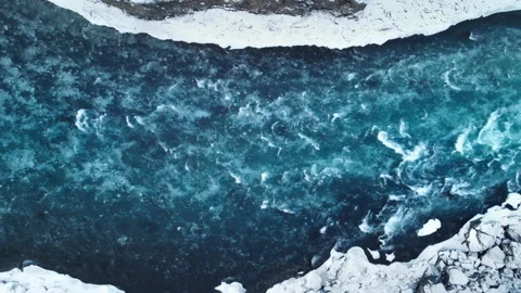 Strong streams of cold blue water and melting ice from waterfall. Natural Stock Footage 166838023