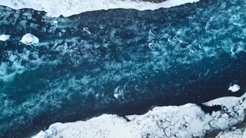 Strong streams of cold blue water and melting ice from waterfall. Natural Stock Footage 166838132