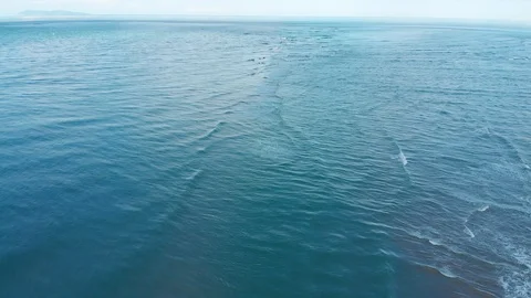 A strong tidal rip flows over a sand bar hidden just beneath the surface Stock-Footage 123990219
