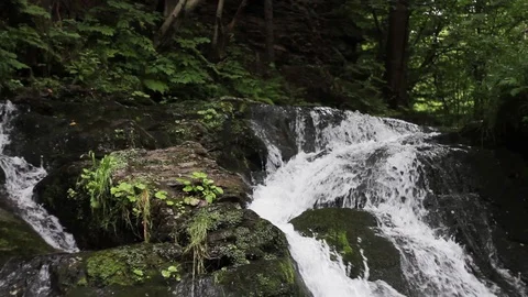 Strong water flow running over the rocks. Forming waterfall, natural wonder Stock Footage 99605672