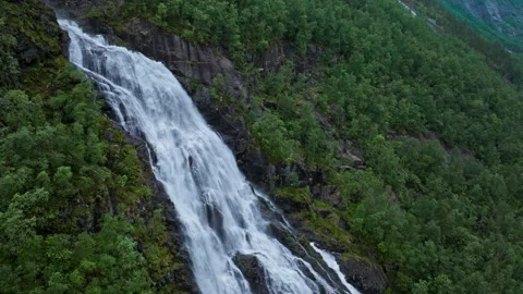 Strong waterfall cascading down cliff at Flesefossen in Brattlandsdalen, Norway. Stock Footage 328132490