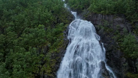 Strong waterfall plunging down steep rock face at Flesefossen, Norway. Stock Footage 328132718