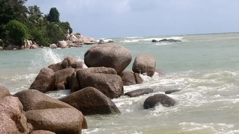 Strong waves crash against large rocks on Trikora Beach, Bintan, Riau Islands Video stock 280892857