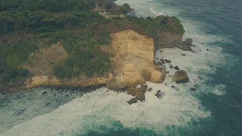 Strong waves hitting the big rocks in Baron beach, Yogyakarta, Indonesia Stock Footage 91879925