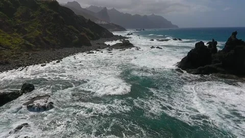 Strong waves roll onto the rocky shore of Benijo Beach 스톡 동영상 219290340