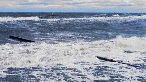 Strong waves on the sea on a cloudy day against a dark sky. Overall plan Stock Footage 254278601