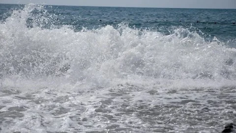 Strong waves on the seacoast with pebbles and large stones on the shore. Stock Footage 334120661
