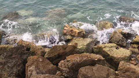 Strong waves splashing over stones. Sea waves hitting the rocky coast. Ocean Stock Footage 102153441