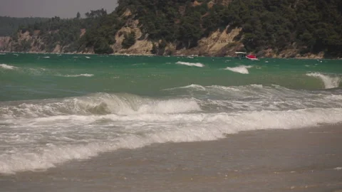 A strong wind blowing over the blue-green Mediterranean sea with powerboats a Stock Footage 131930338
